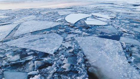 stunning footage as a drone glides over immense ice formations in the water