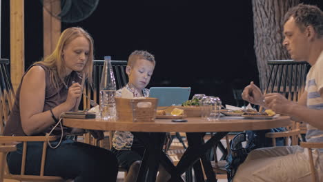 family having meal in outdoor cafe