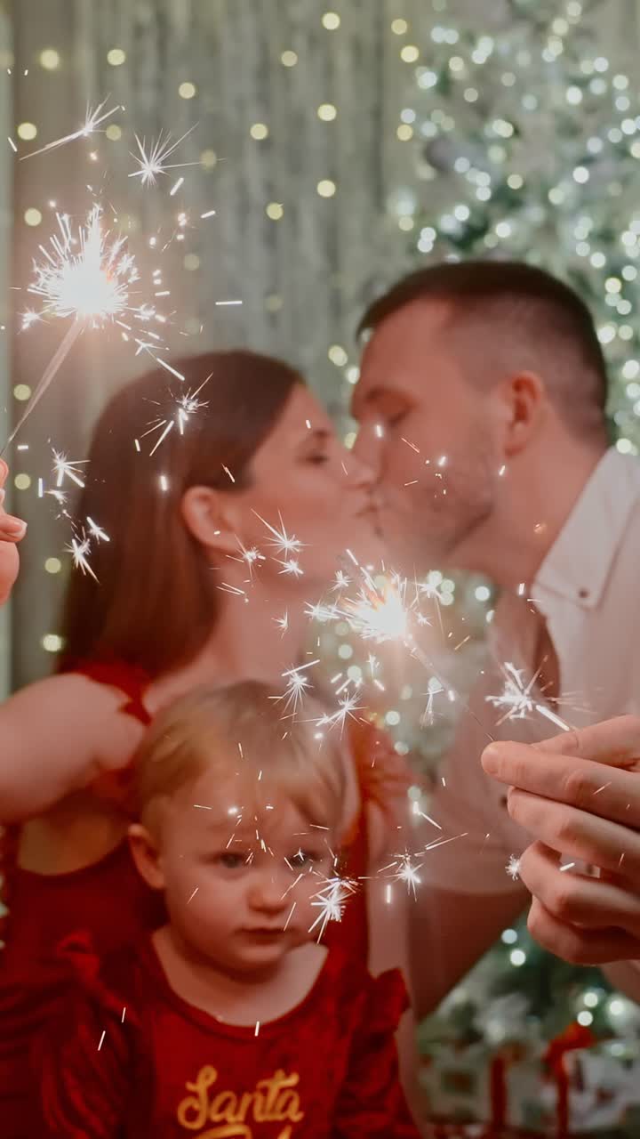 Celebrating Together: A Joyful Family Holiday Scene with Sparklers, Smiling Faces, and a Festive Christmas Tree in the Background, Capturing Moments of Laughter and Togetherness during Winter Festivities