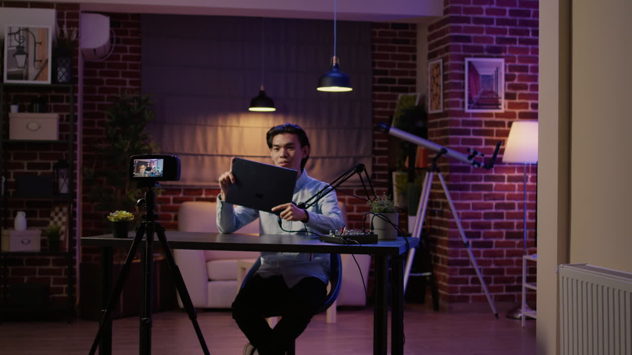 Asian man recording a podcast in a studio