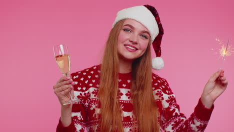 Christmas-Girl-dancing-with-bengal-sparklers-fireworks-and-champagne,-sending-wishes-congratulation