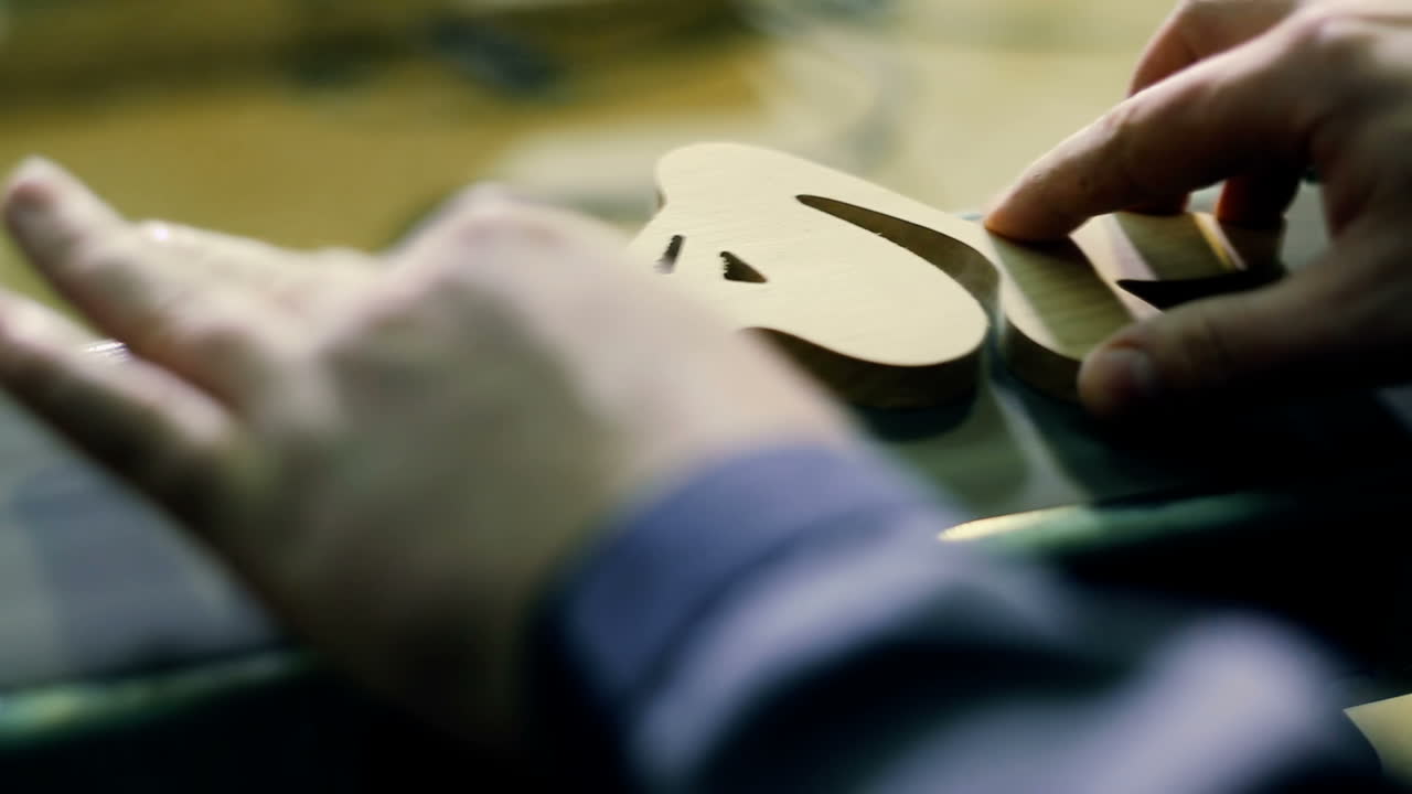 Carpenter Sending Piece Of Timber In His Workshop. Carpenter using electric sander. Carpenter sanding a wood with sander