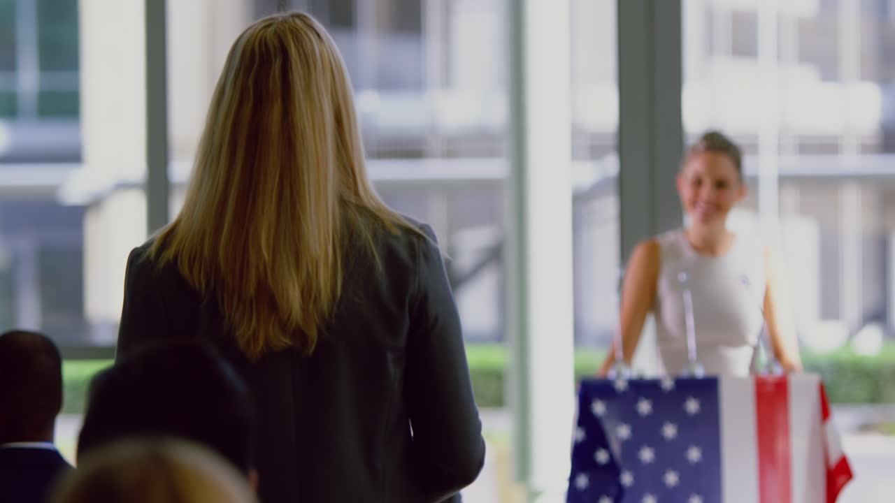 Businesswoman interacting with female speaker in a political campaign 4k