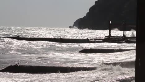 waves crashing against breakwater on a stormy coast