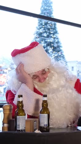 funny drunk santa claus in pub merry christmas funny drunk santa claus in pub psychologically exhausted santa claus with a bottle of beer merry christmas