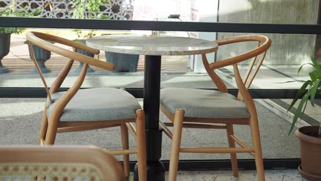 empty table and chairs at an outdoor cafe