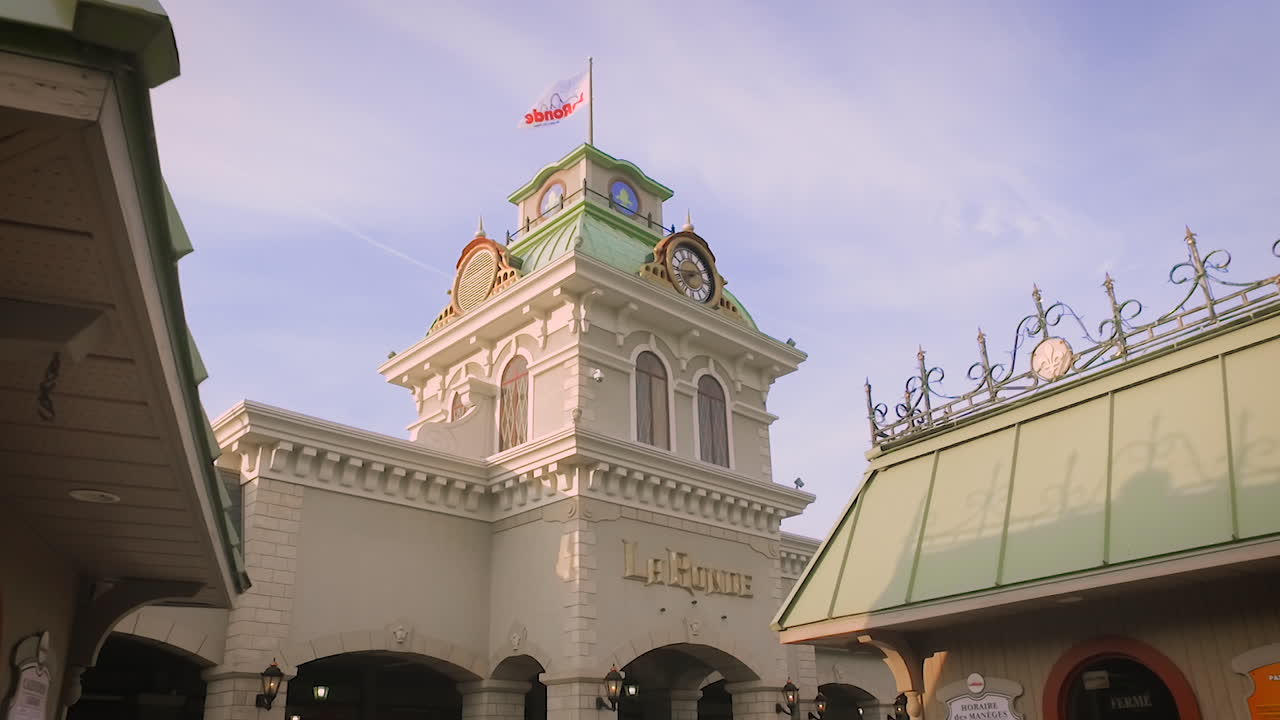A large clock tower stands above a royal building