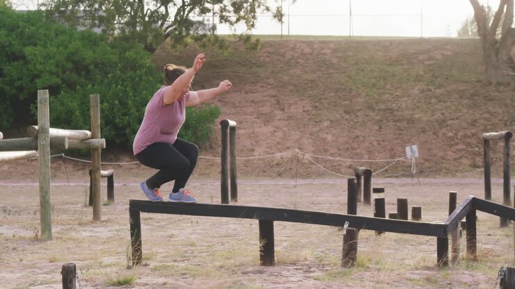 Caucasian woman exercising at bootcamp