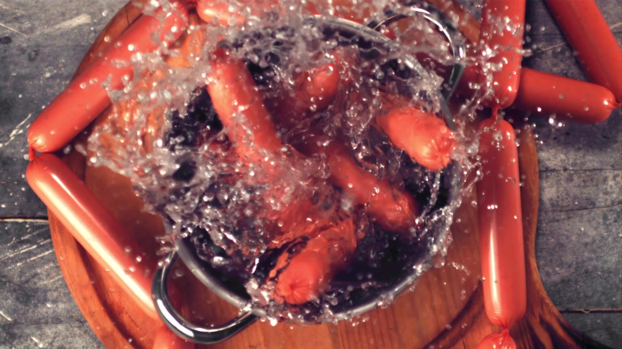 Sausages Falling into a Pot of Water in Slow Motion