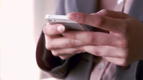 businesswoman typing on her smartphone