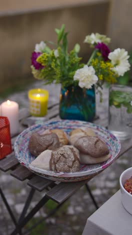 outdoor garden dining with flowers and bread