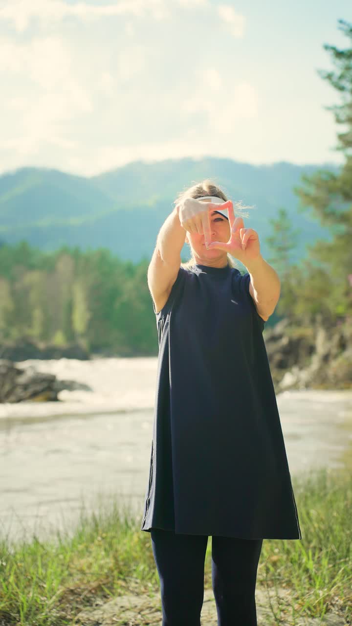 Woman Posing Outdoors with Hands Framing a View