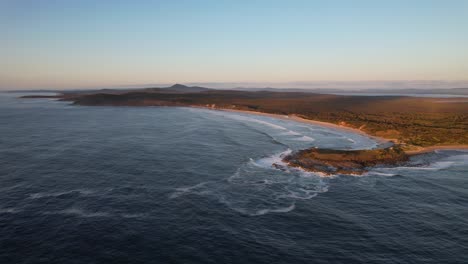 angourie back beach and angourie point beach at sunset in nsw, australia - aerial shot