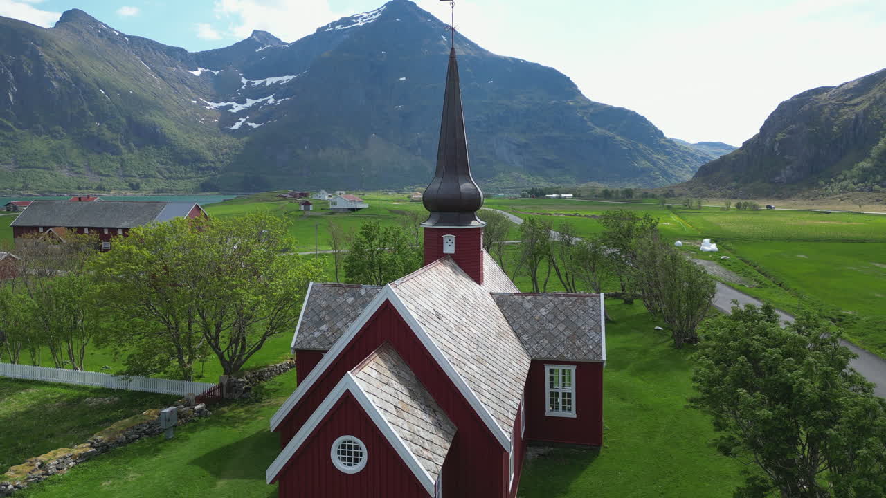 Cinematic aerial view over the beautiful Flakstad church on the Lofoten islands on a spring day