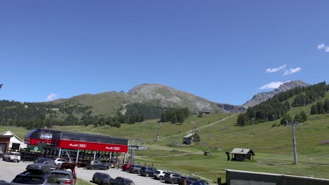 scenic mountain landscape with buildings and cars