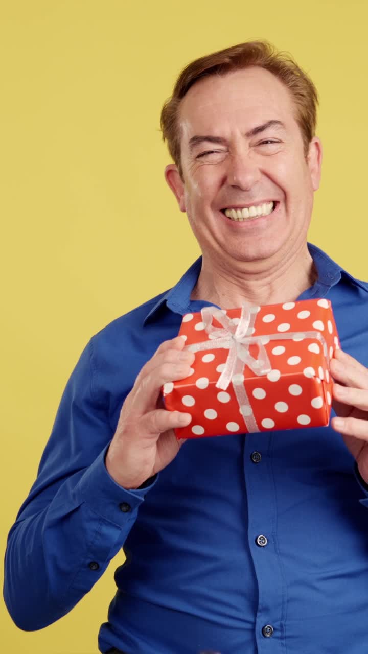 A happy man poses with and without a gift against a yellow background