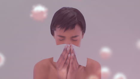 animación de células de virus sobre una mujer biracial estornudando