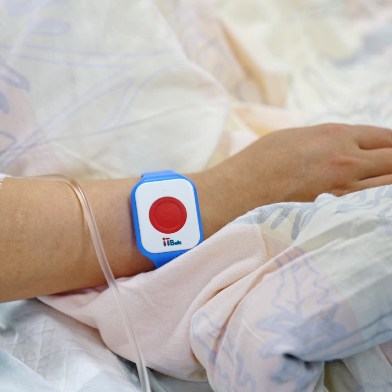Hand of a woman lying in bed with medical equipment attached. Close up. Female patient in hospital