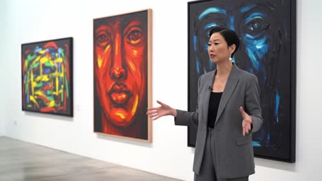 an engaging art discussion: exploring vibrant portraits and expressions in a modern gallery setting