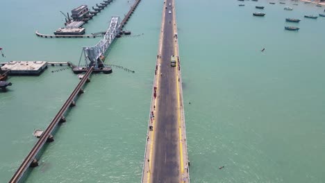 aerial drone shot over the serene city of rameshwaram, highlighting its famed bridge and surrounding waters.