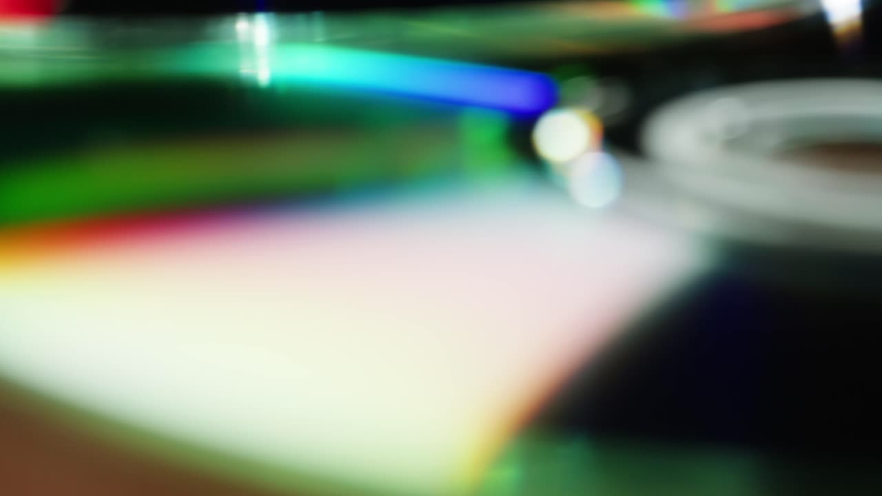 CD disks on black background close-up. Old vintage disks for DVD player or computer. Music recorder, playing retro computer games.