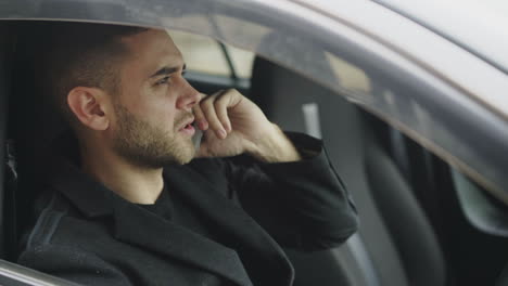 man coughing in car