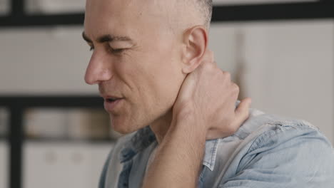 middle aged man having neck pain at home