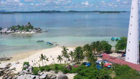 aerial of beautiful white sand beach with tourists visiting lengkuas island in belitung indonesia