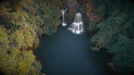 aerial view of a waterfall in a lush green forest