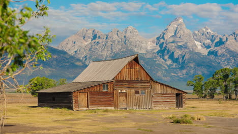 historic barn with grand teton mountains in the background