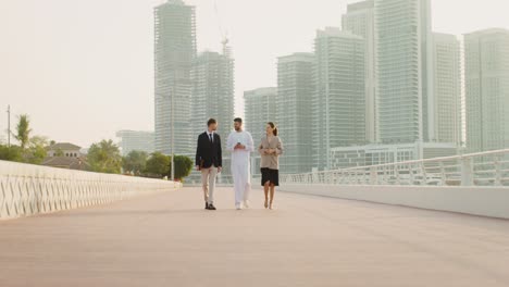 business professionals walking on a bridge in dubai