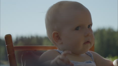 portrait of cute baby face reacting to sound outdoors