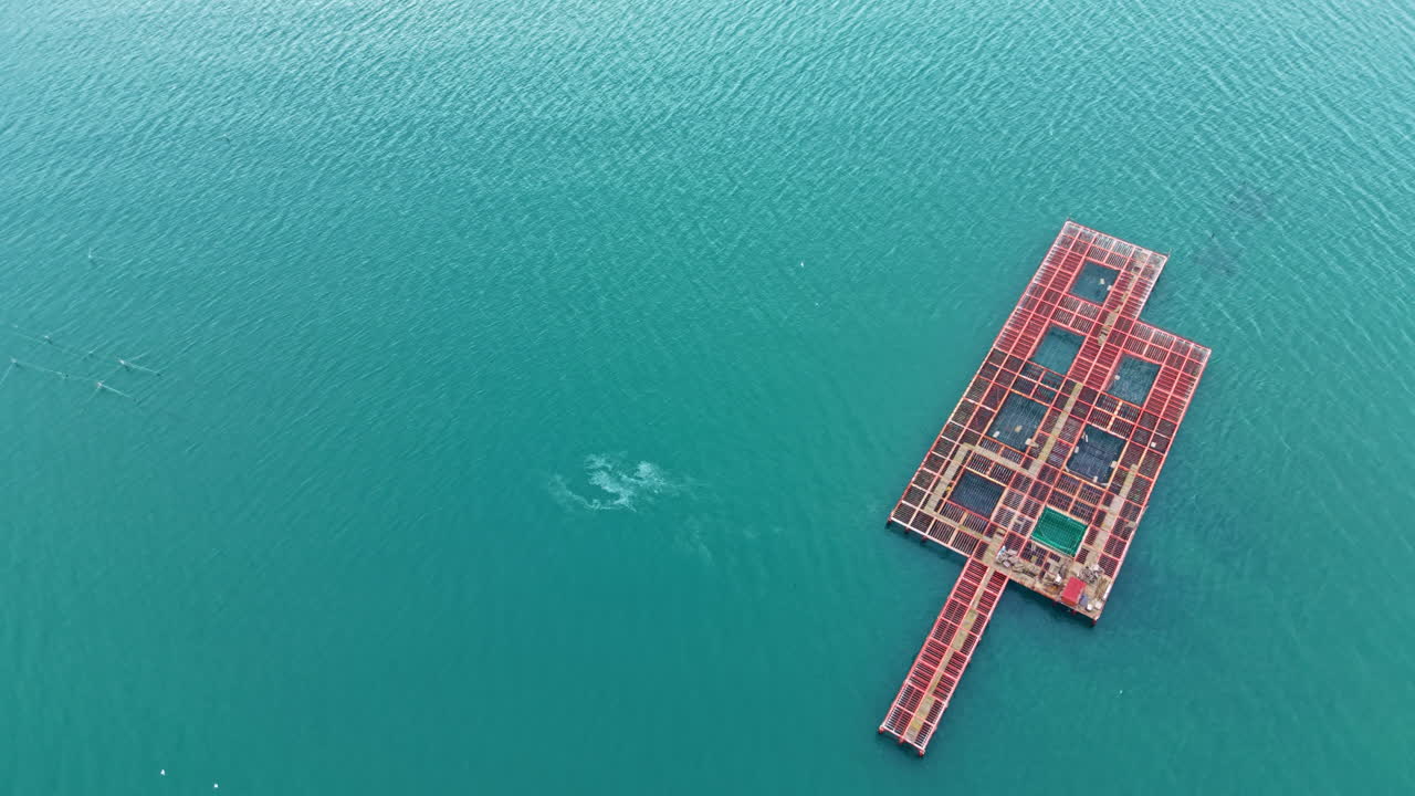Mussel farm located in the sea showing floating structures and calm water in the background during daylight
