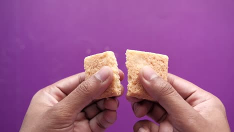 hands holding a broken cookie