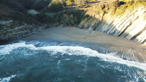 muriola-beach:-aerial-view-of-the-shore-of-the-beautiful-beach-on-a-sunny-day-in-Barrika,-Vizcaya