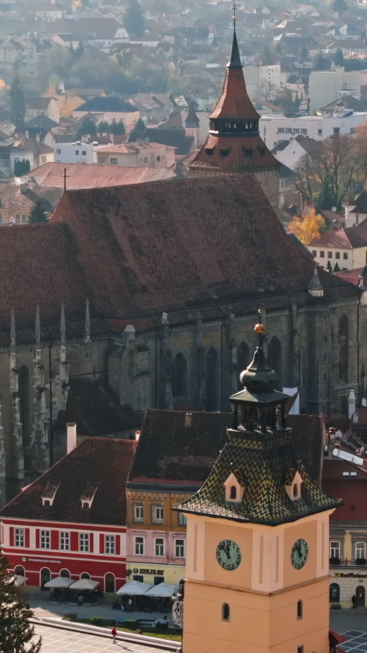 Aerial drone view of the Christmas tree being installed in The Council Square in the historic center of Brasov, Romania. Vertical