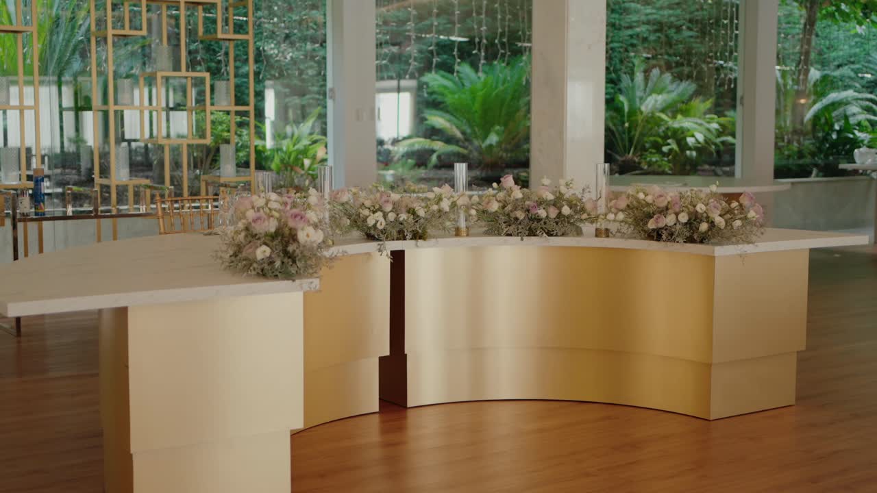 Elegant Wedding Reception Decor with Gold Table and Floral Arrangements