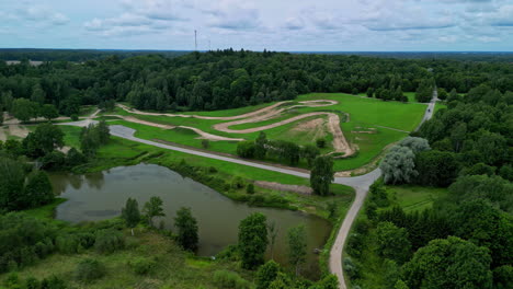 aerial drone dolly forward view of a small outdoor dirt racing track