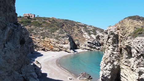 aerial between the rocks revealing the kaladi beach, kythira island, greece