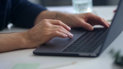 close-up view of man hands surfing internet on computer touchpad