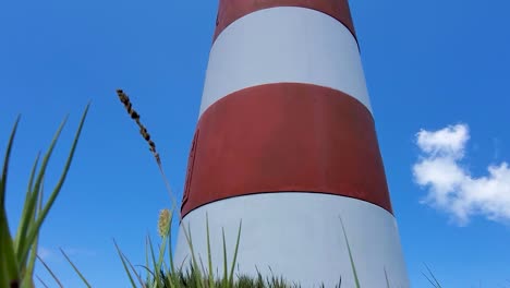 close up red and white lighthouse in cayo de agua island, los roques venezuela,