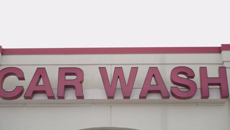 Panning-shot-of-a-car-wash-sign-on-a-building-in-the-United-States