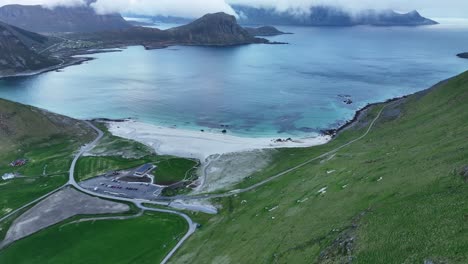 calm midnight sun view of haukland beach from mannen mountain ridge, lofoten, norway