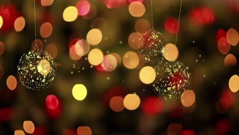 animation of gold christmas baubles swinging over defocussed red and yellow flashing fairy lights