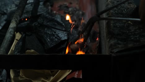 closeup view of lighting up charcoal for bbq grill