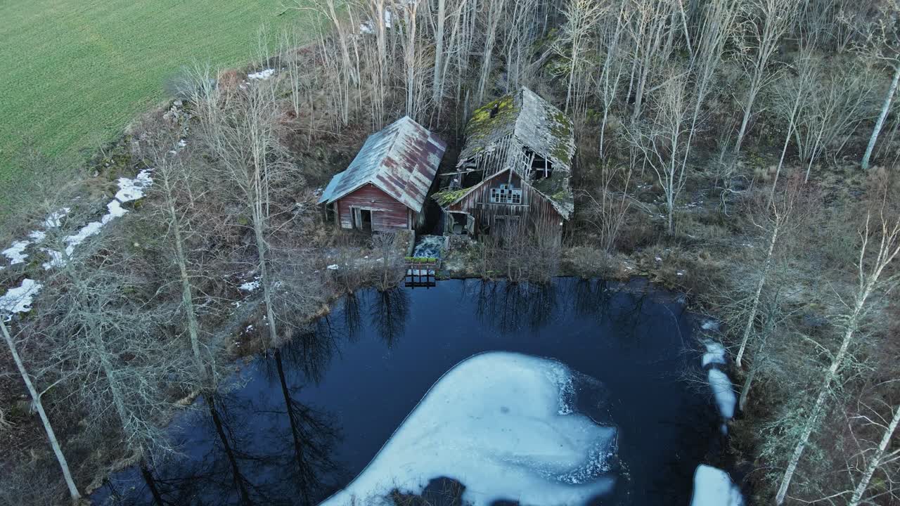 Beautiful aerial of a scary, abandoned sawmill in the forests of rural Sweden