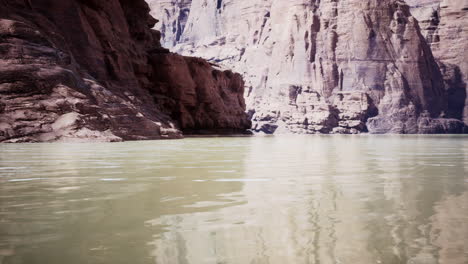 a breathtaking view of a river flowing through a narrow canyon with high rock cliffs on both sides.