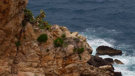 ocean waves crashing on rocky coastline in taormina, sicily, italy (italia), windy day