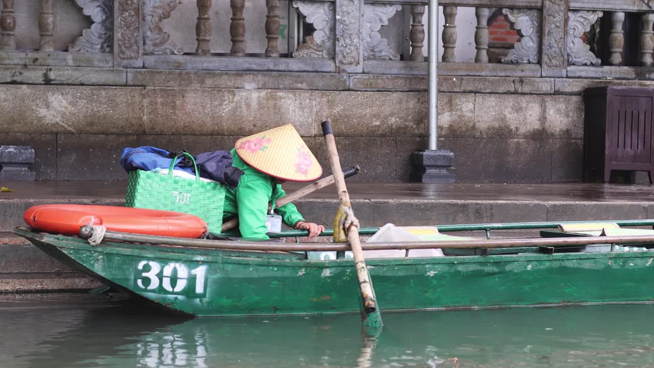Person rowing a boat along a canal