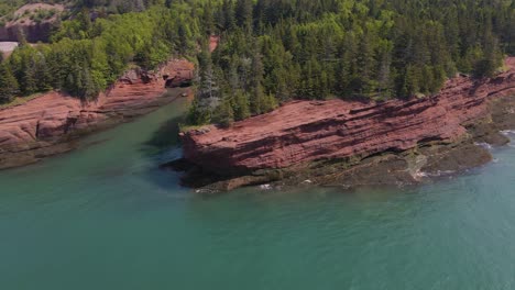 drone shot on a beautiful sunny day of the popular st martins cave located on the bay of fundy, in the province of new brunswick in canada shot in 4k during a hot summer day